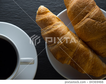 Cup of coffe and croissants Cup of coffe and croissants 84369466