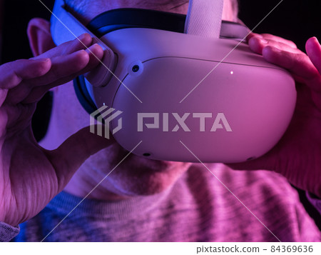 Man wearing a virtual reality headset Man wearing a virtual reality headset 84369636