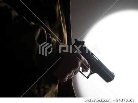 Man holding a gun Man holding a gun 84370105