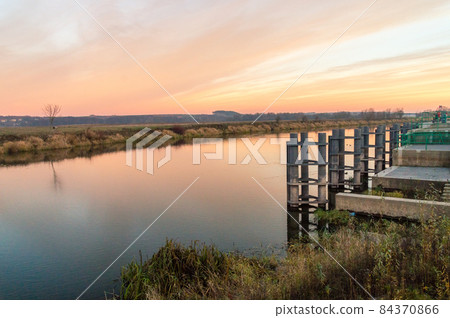 Orange sunset over Narew river in Lomza, Poland. Orange sunset over Narew river in Lomza, Poland. 84370866