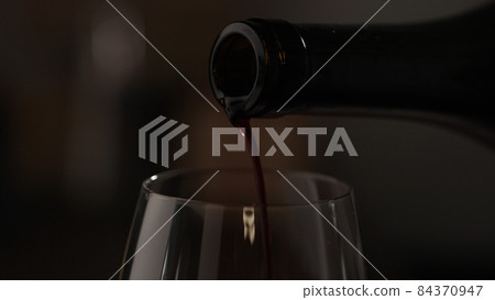 pour red wine into wineglass closeup pour red wine into wineglass closeup 84370947
