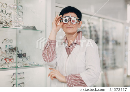 Portrait of an optometrist ophthalmologist middle aged woman Portrait of an optometrist ophthalmologist middle aged woman 84372557