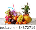 Tropical fruits on wooden table isolated on white 84372719
