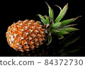 Single whole pineapple with reflection lies rotated 84372730
