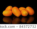 Heap of ripe kumquats on black background 84372732