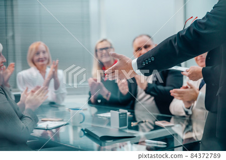 through the blinds. group of business people sitting at the negotiating table through the blinds. group of business people sitting at the negotiating table 84372789