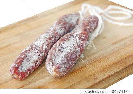 Mature air dried sausage. Spanish traditional sausage Fuet on wooden board. Mature air dried sausage. Spanish traditional sausage Fuet on wooden board. 84374421
