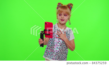 Happy funky blogger child kid girl, recording funny dancing video on smartphone for social network 84375259