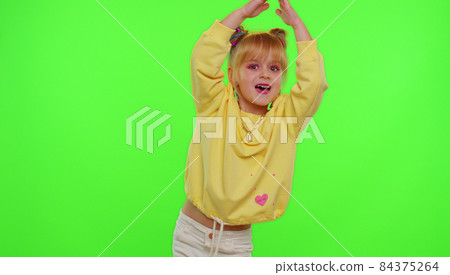 Dancing young little kid girl blogger record dance moves at camera for social media content on phone Dancing young little kid girl blogger record dance moves at camera for social media content on phone 84375264