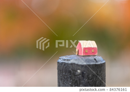 A small cute red house (autumn colored tree background) A small cute red house (autumn colored tree background) 84376161