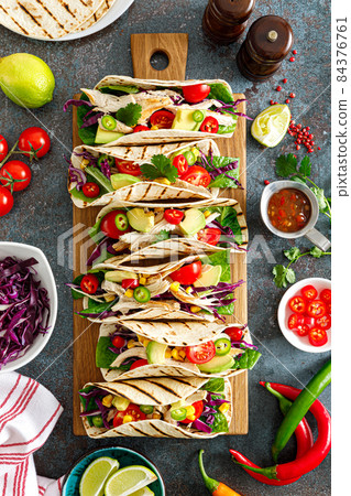 Chicken tacos with grilled meat, avocado, fresh vegetable salad and sauce salsa Chicken tacos with grilled meat, avocado, fresh vegetable salad and sauce salsa 84376761
