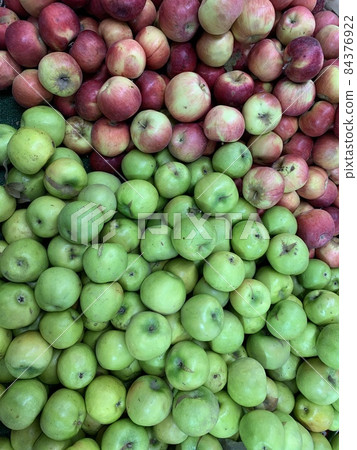 lots of ripe sweet apples for food as a background 84376922