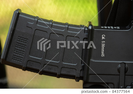 Close-up parts of automatic weapon with selective focus and blurred background 84377564