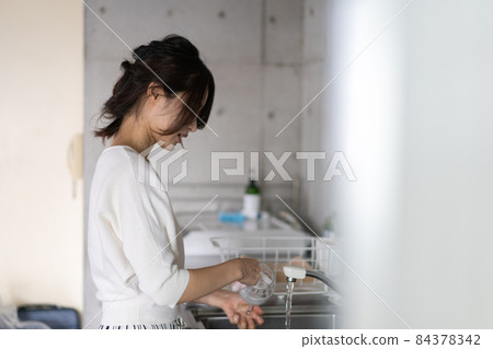 Young woman washing at home Young woman washing at home 84378342