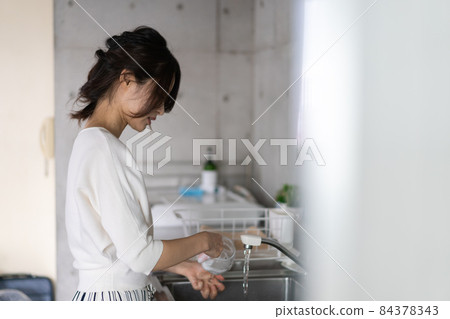 Young woman washing at home Young woman washing at home 84378343