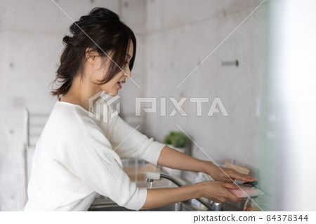 Young woman washing at home Young woman washing at home 84378344