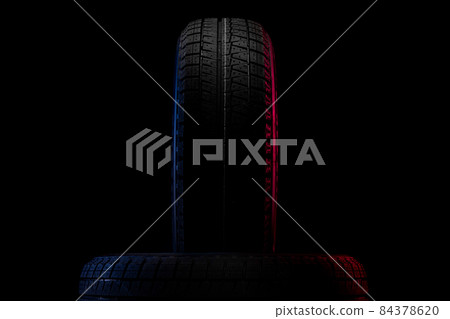 tires with a tread for driving in winter close-up on a black background 84378620