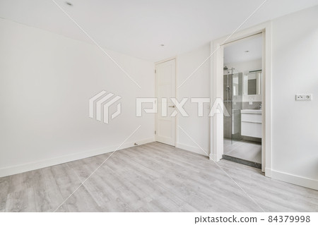 Modern room with wooden floor and white walls 84379998