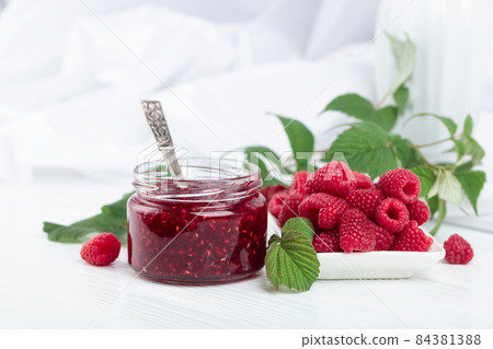 Jar of raspberry jam and fresh berries. Jar of raspberry jam and fresh berries. 84381388