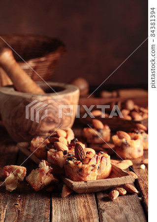 Small cakes with almonds, raisins, and honey. Small cakes with almonds, raisins, and honey. 84381394
