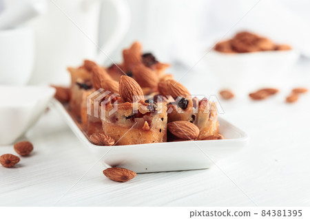 Small cakes with almonds, raisins, and honey. 84381395