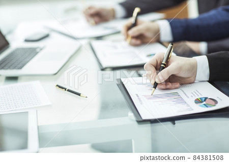 closeup of business team is working with the financial schedules in the workplace in the office closeup of business team is working with the financial schedules in the workplace in the office 84381508