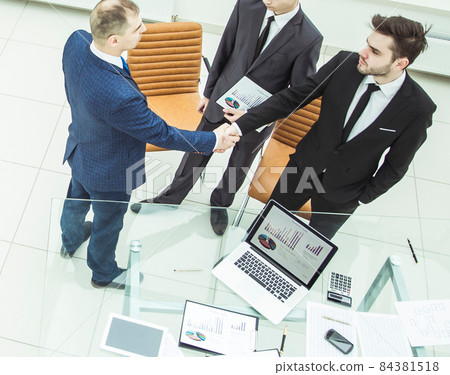 business partners shake hands before starting a business meeting business partners shake hands before starting a business meeting 84381518