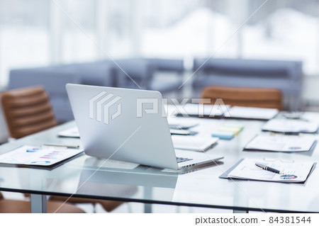 laptop and documents on the desktop in the accounting Department of the company laptop and documents on the desktop in the accounting Department of the company 84381544