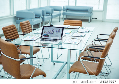 open laptop computer with financial charts and papers spread out on the desktop before starting business negotiations open laptop computer with financial charts and papers spread out on the desktop before starting business negotiations 84381557