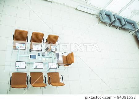 top view - a place for business meetings in the modern conference room. on the desktop, top view - a place for business meetings in the modern conference room. on the desktop, 84381558