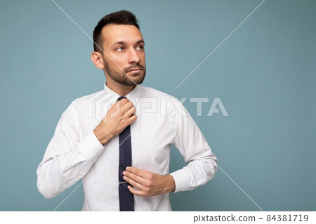 Photo of positive self-confident young handsome brunet unshaven male business man with beard wearing Photo of positive self-confident young handsome brunet unshaven male business man with beard wearing 84381719
