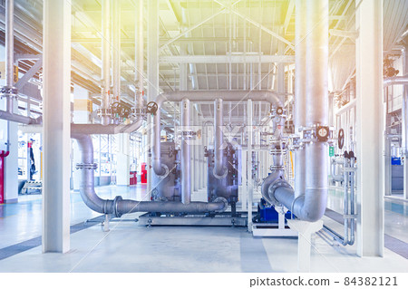 Photo of pipes and tanks. Chemistry and medicine production. Pharmaceutical factory. Yellow light 84382121