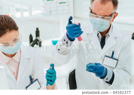 close up. researchers work with tests in the laboratory. close up. researchers work with tests in the laboratory. 84382377