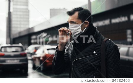 close up. casual man Smoking standing on the street 84382403