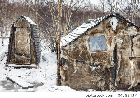 Outdoor toilet and outbuildings insulated with reindeer skins in the northern village. 84383437