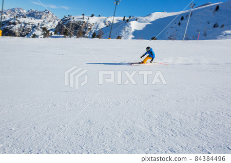 Alpine skier on slope at Cortina Alpine skier on slope at Cortina 84384496