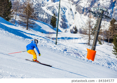 Alpine skier on slope at Cortina 84384577