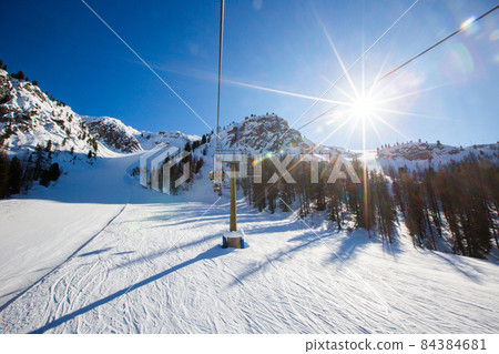 Alpine ski chair lift and slope Alpine ski chair lift and slope 84384681