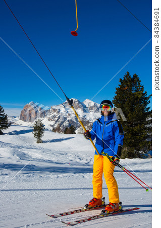 Alpine skier with T-bar lift Alpine skier with T-bar lift 84384691