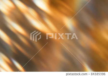 Blur glow overlay. Bokeh rays. Sunlight beam glare. Gleam leak. Defocused golden orange black light flecks on dark abstract background. 84385396