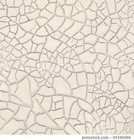 Cracked white clay on dried lakebed, surface texture 84386066