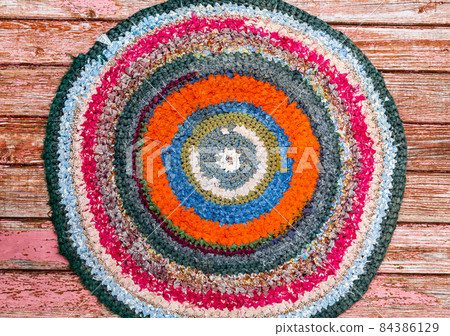 Colorful vintage handicraft rug made from strips of cloth as background 84386129