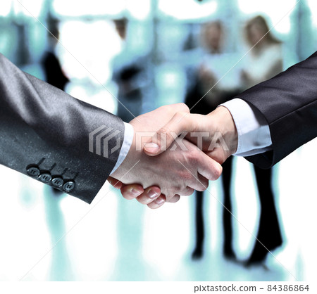 Close-up of business people shaking hands to confirm their partnership Close-up of business people shaking hands to confirm their partnership 84386864