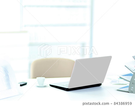 Demonstration of a laptop in the office of the rear view. 84386959