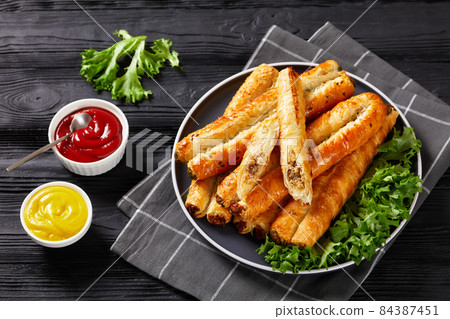 Rollini with chicken meat filling on a plate 84387451