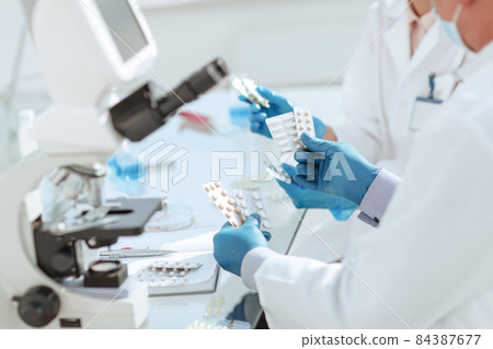 close up. scientists are testing samples of new drugs . close up. scientists are testing samples of new drugs . 84387677