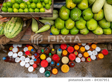 Green Fruits and Jars with Sauces on a Local Market in Dar es Salaam, Tanzania 84387951