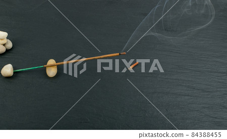 Burning incense aroma sticks with smoke on black background Burning incense aroma sticks with smoke on black background 84388455