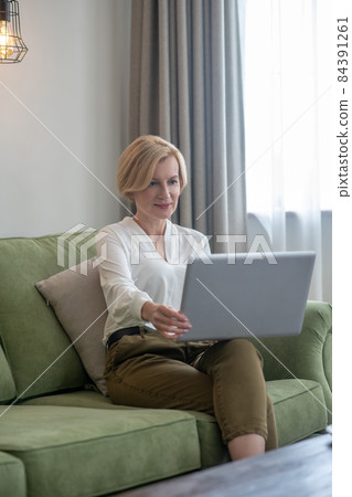 Businesswoman working from home and looking involved 84391261