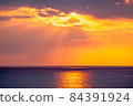Light beam, sunset and sea 84391924